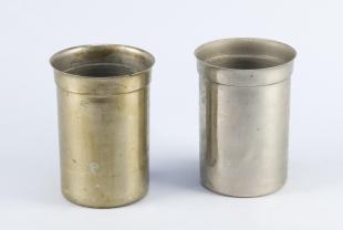 two large nickel beakers