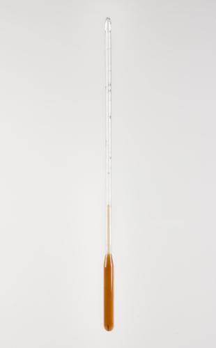 undetermined thermometer filled with amber-colored liquid