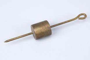 brass weight with hanging loop and wire pointer